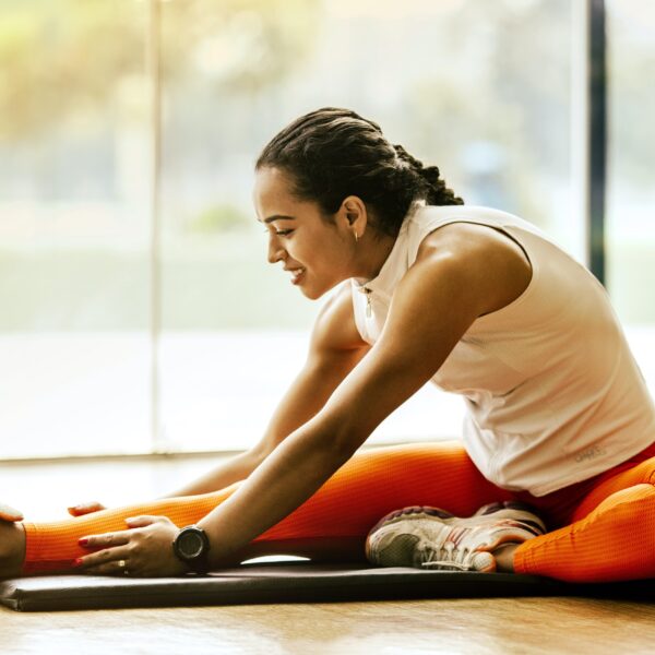 A woman stretching in the gym.