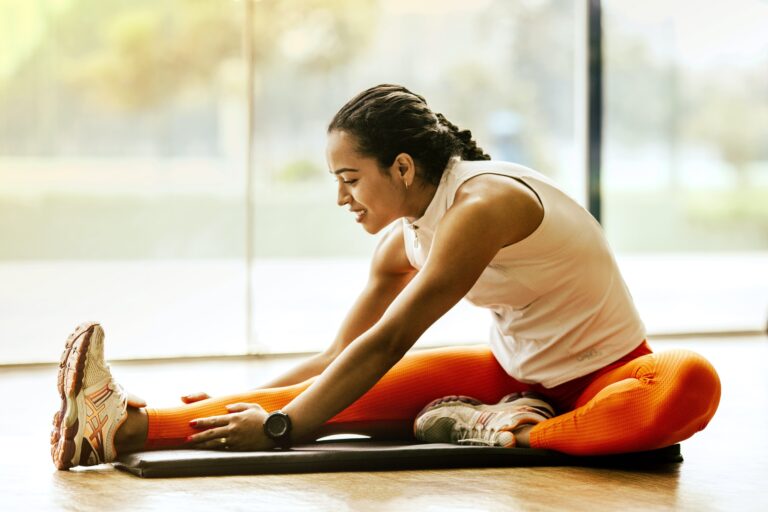 A woman stretching in the gym.