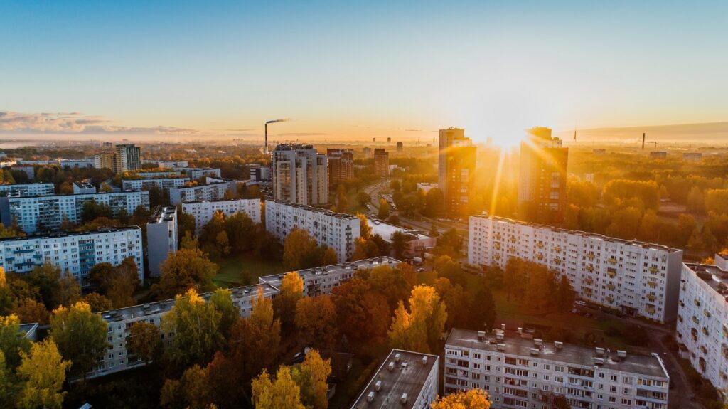 Apartment buildings with a mounting view in the background. There is a beautiful sunset over the mountains.